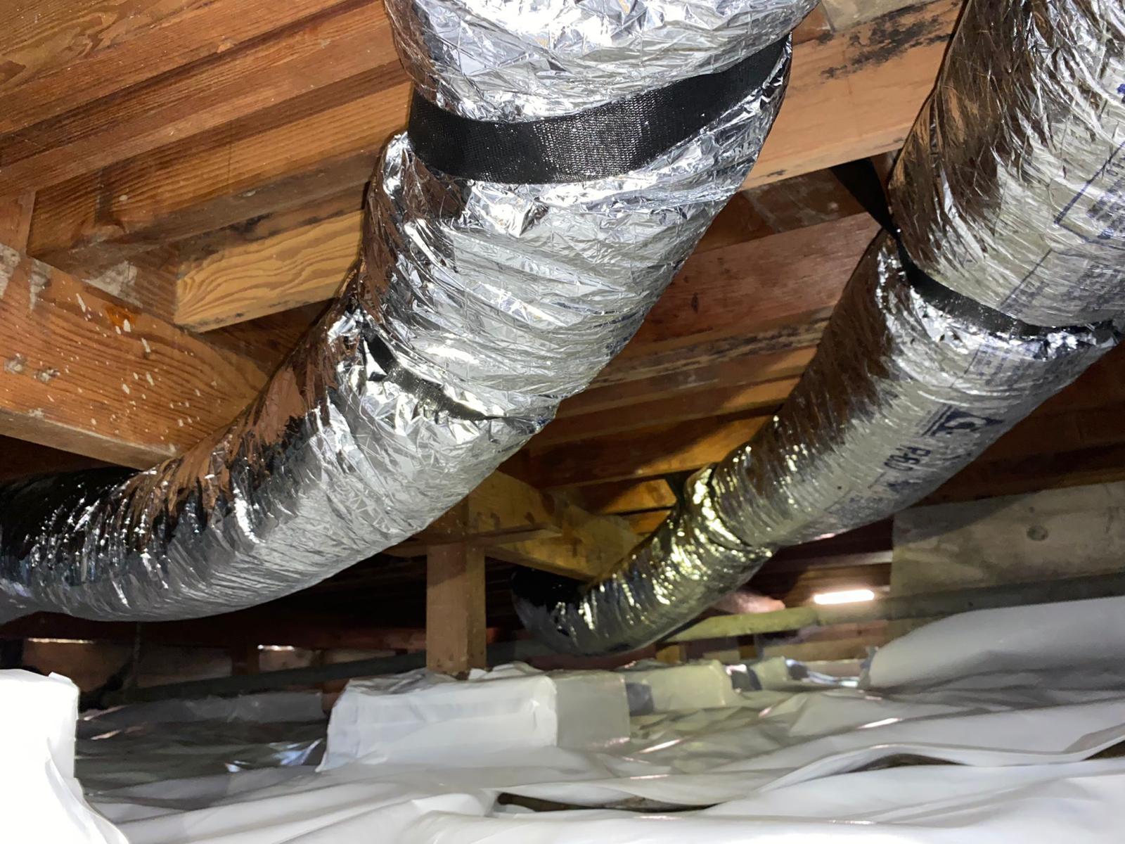 HVAC technician replacing air ducts during professional duct replacement service in California