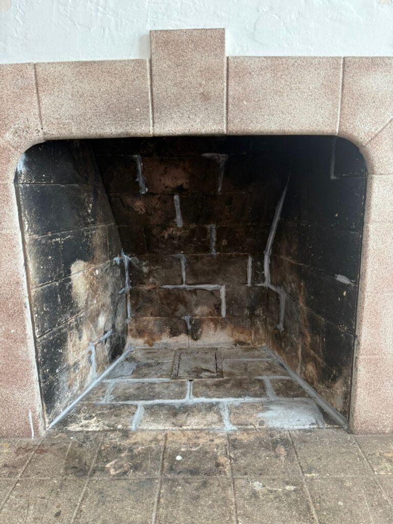 Dirty fireplace chimney with soot buildup before professional chimney cleaning service in California