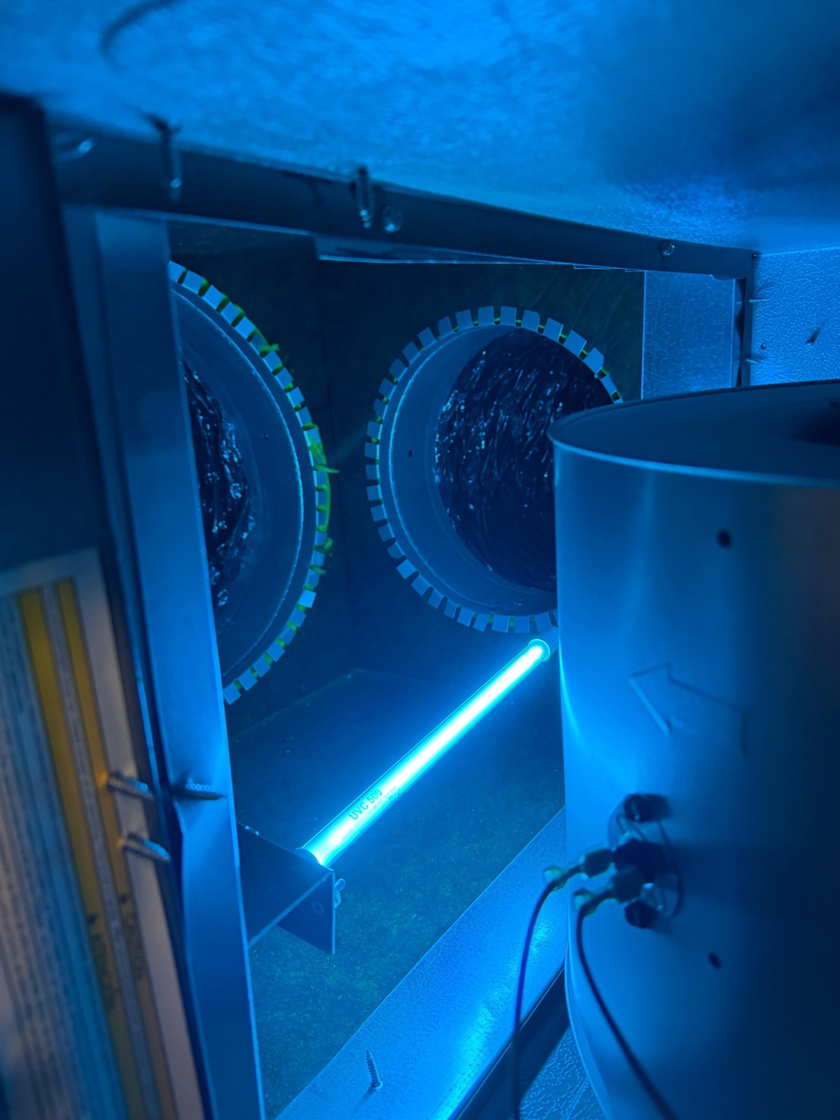 UV-C light glowing inside ductwork