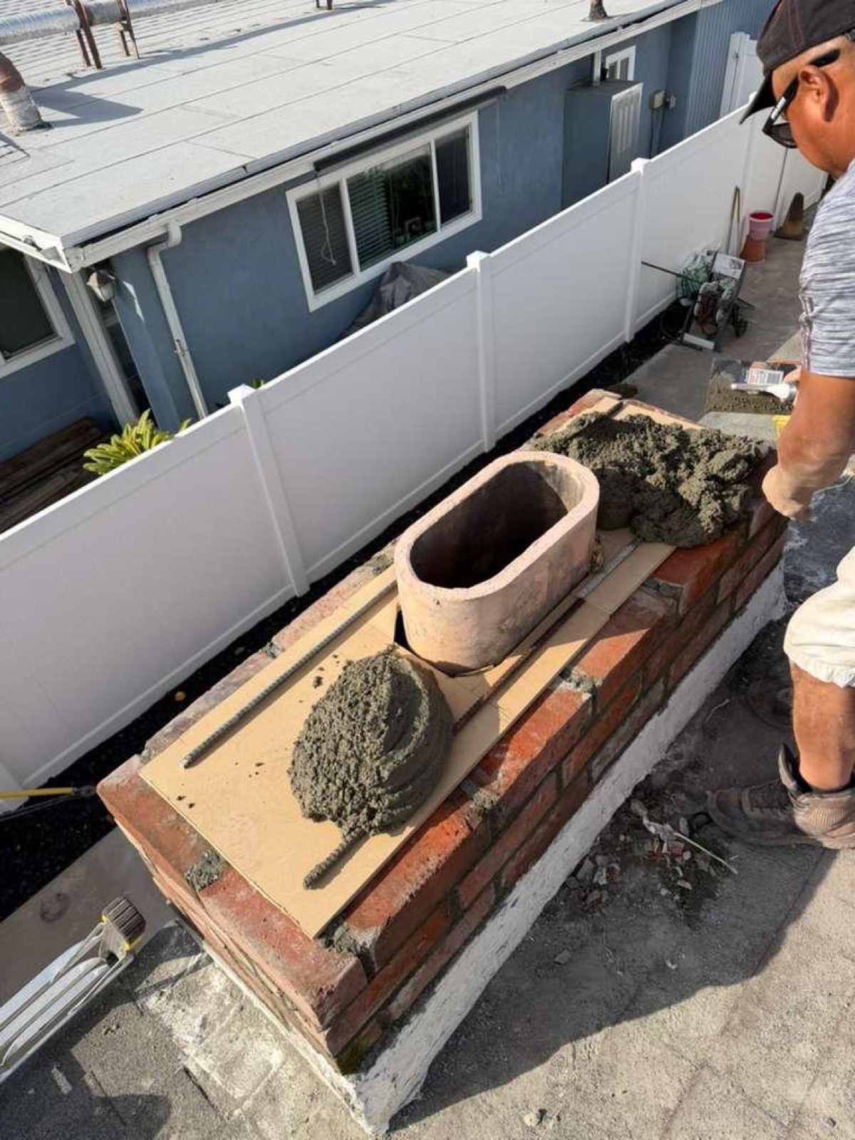 Installing new terracotta flue liner with custom wood form and concrete pour — California Airduct Pros chimney building process
