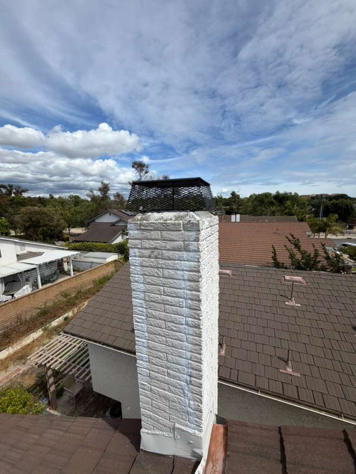 California chimney after professional repair by California Airduct Pros — smooth restored masonry, new stainless steel cap installed, complete weatherproof finish