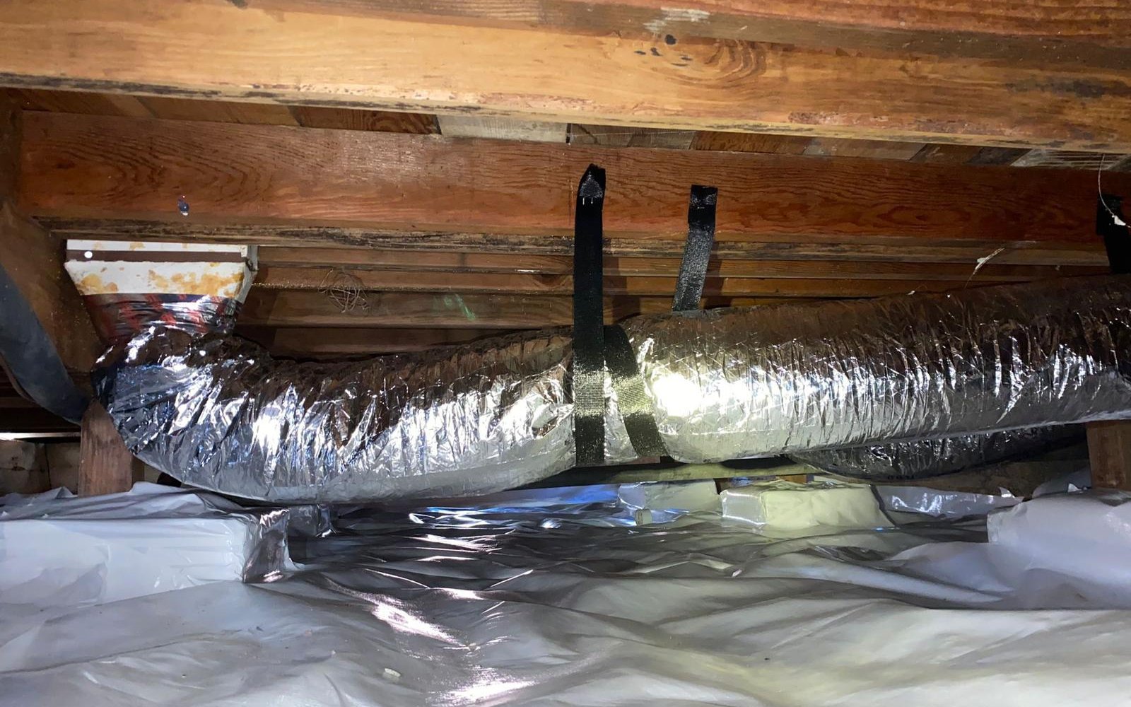 New R-8 insulated flex duct installation in California home crawlspace by California Airduct Pros — code-compliant ductwork properly strapped, supported, and sealed at every joint with UL-181 mastic