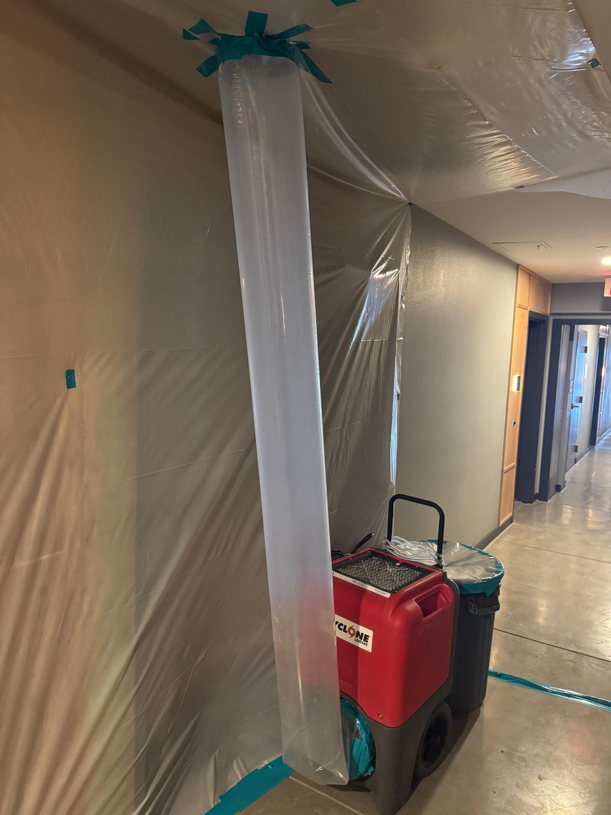 IICRC S520 sealed plastic containment built by California Airduct Pros for mold remediation in a California building — plastic barrier sealed with tape preventing spore migration during removal