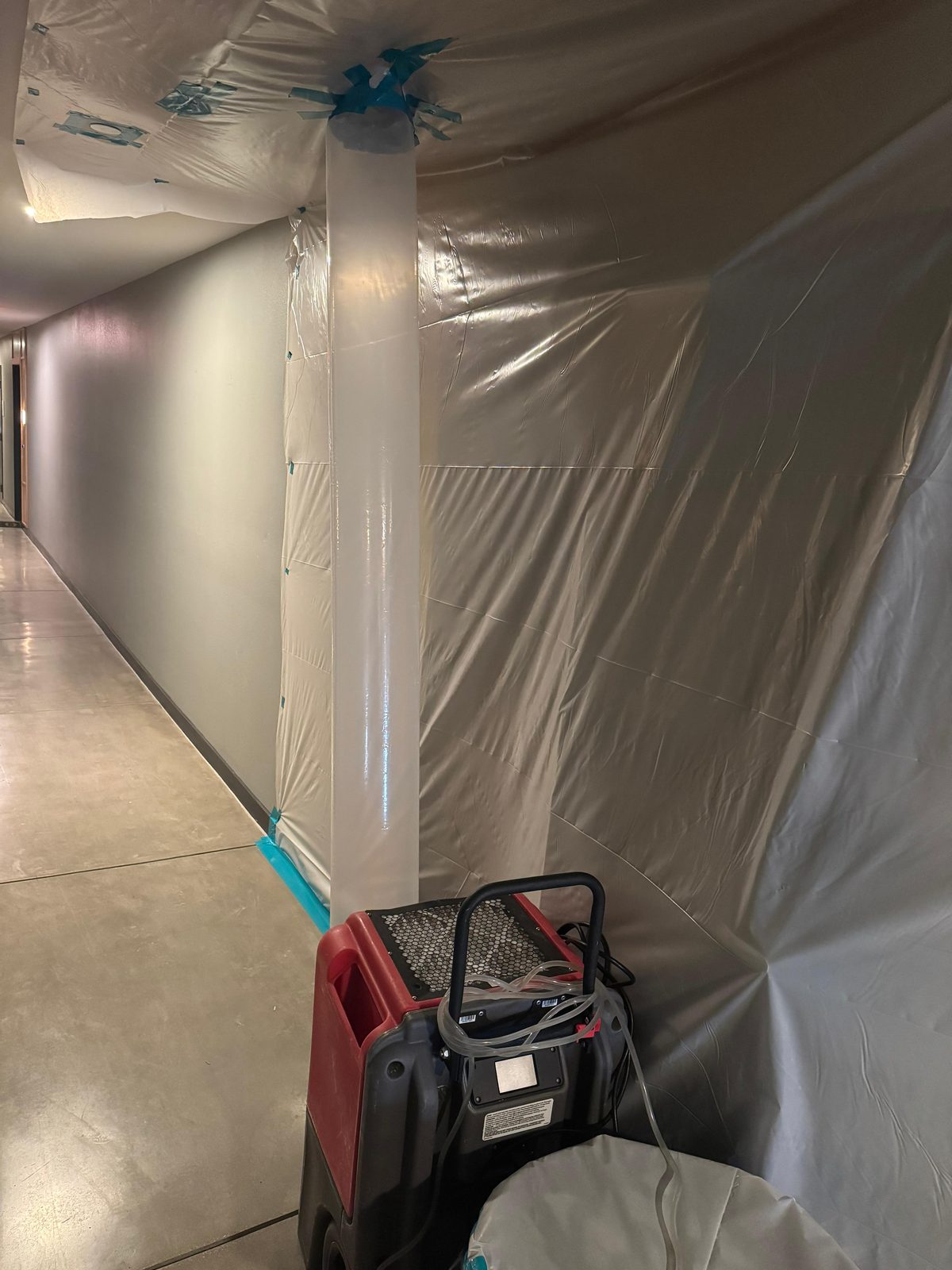HEPA negative-air scrubber machine running inside California Airduct Pros sealed containment — creating negative pressure to capture airborne mold spores during California mold remediation